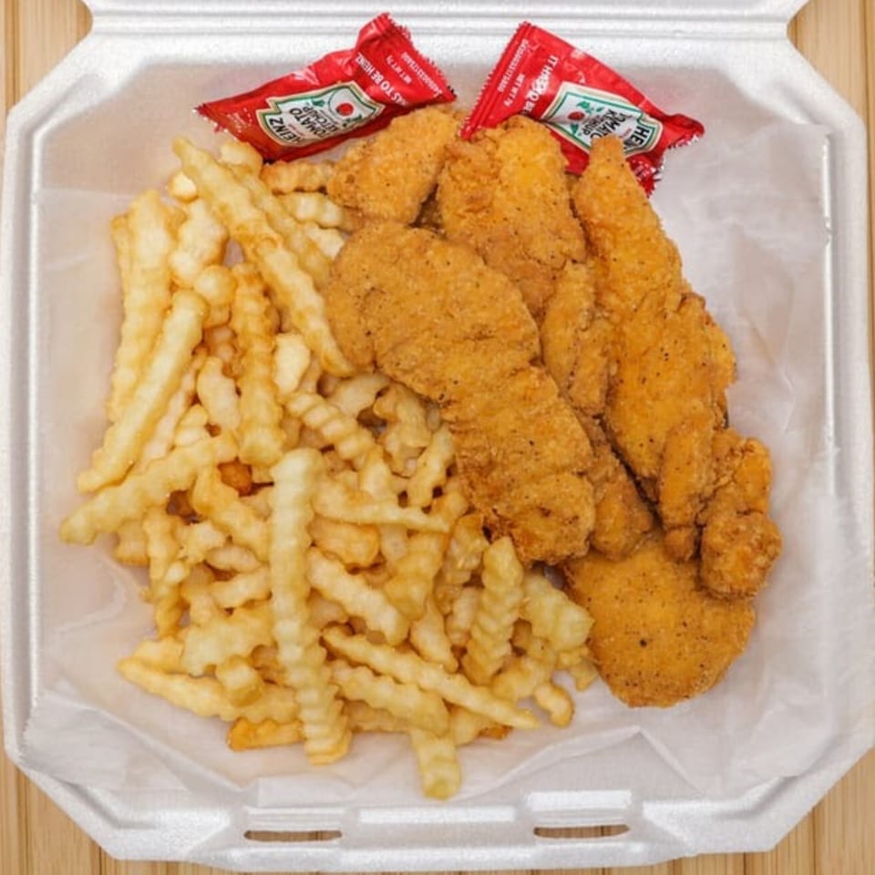 Lee's Deli chicken tenders and crinkle-cut fries with two ketchup packets in a white takeout container.
