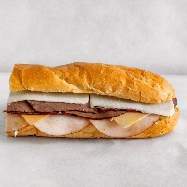 Lee's Deli sub sandwich with roast beef, turkey, provolone, and American cheese on a white background.